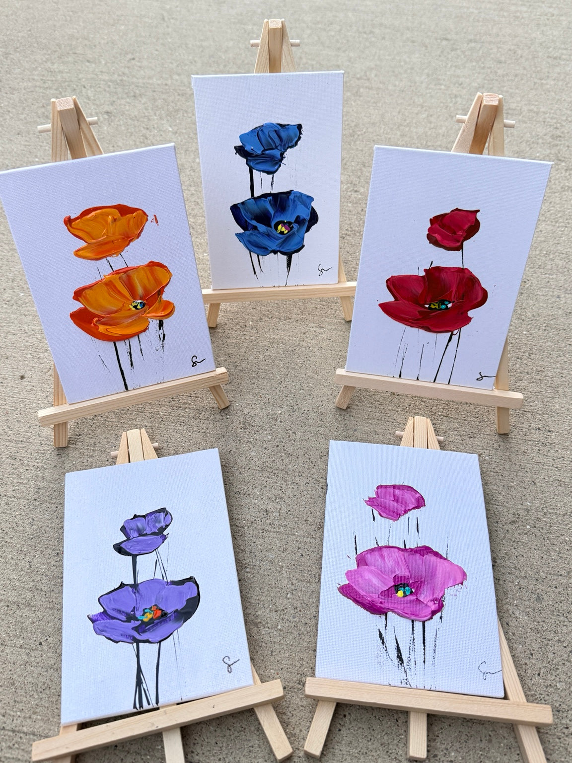 Sam Glenn 4x6 poppy paintings in all five colors on wooden easels