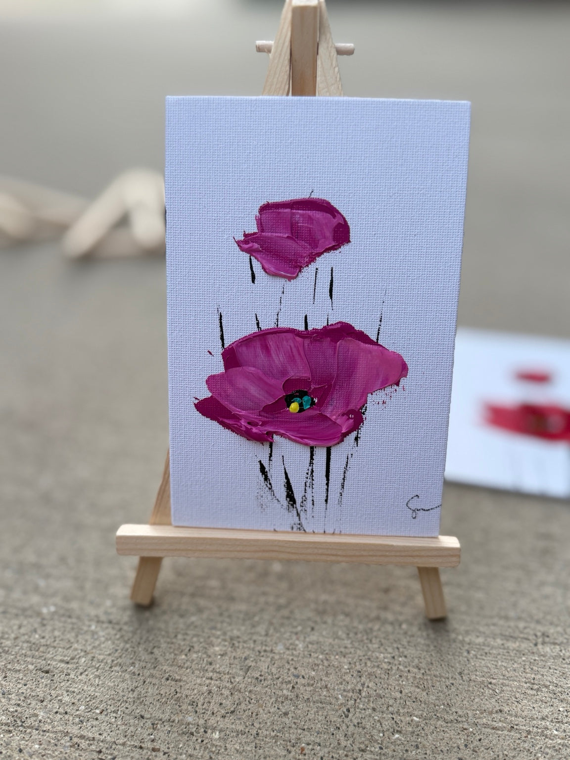 Magenta Sam Glenn poppy painting on a 4x6 canvas board with a wooden easel