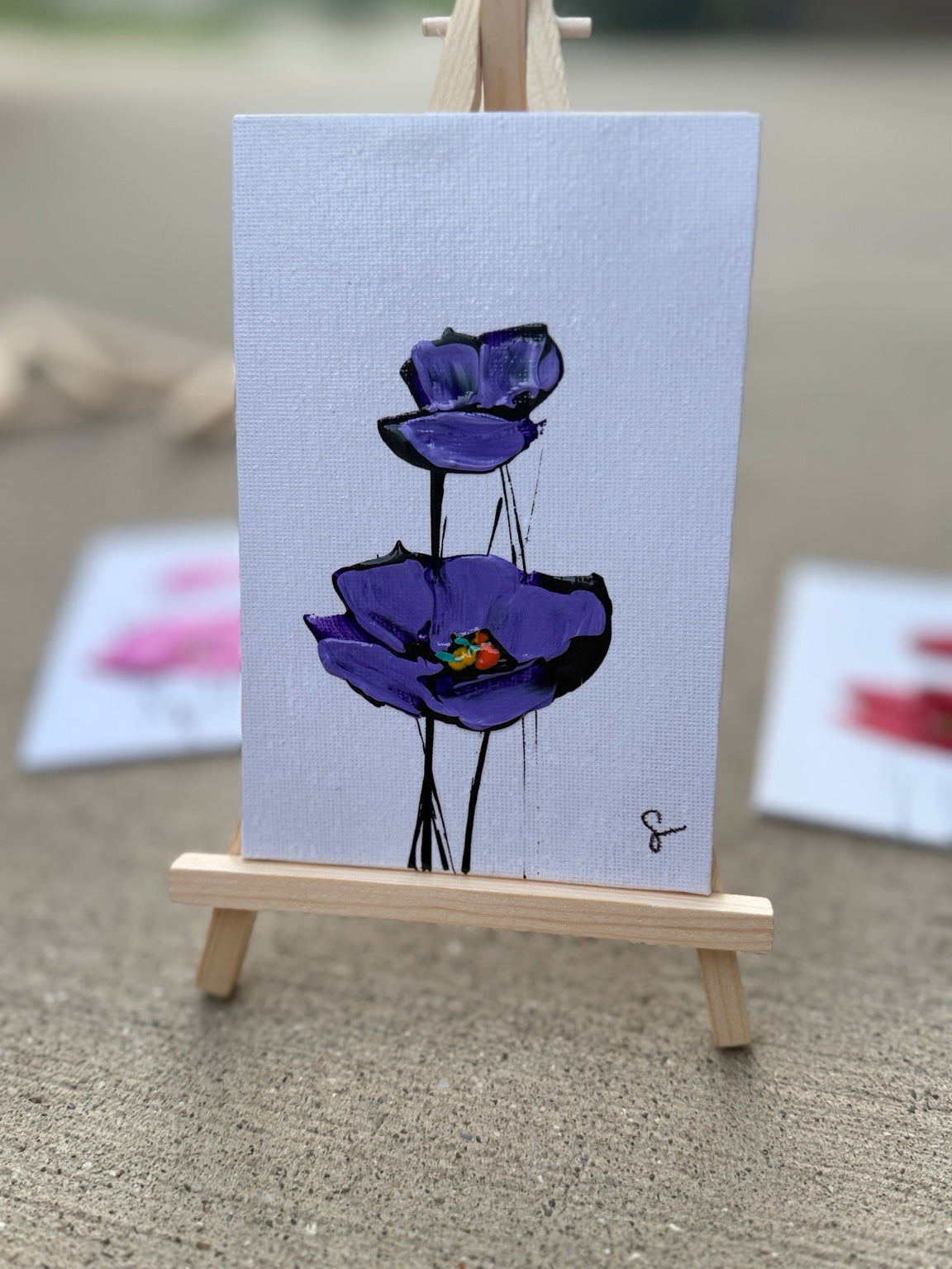 Purple Sam Glenn poppy painting on a 4x6 canvas board with a wooden easel
